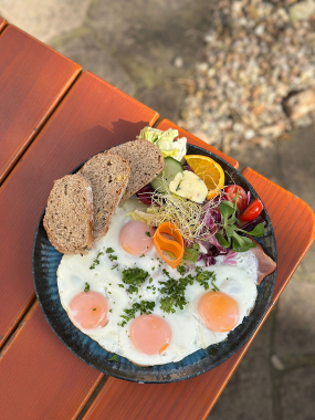 Čtyři sázená vejce s opečenou slaninou a farmářským chlebem